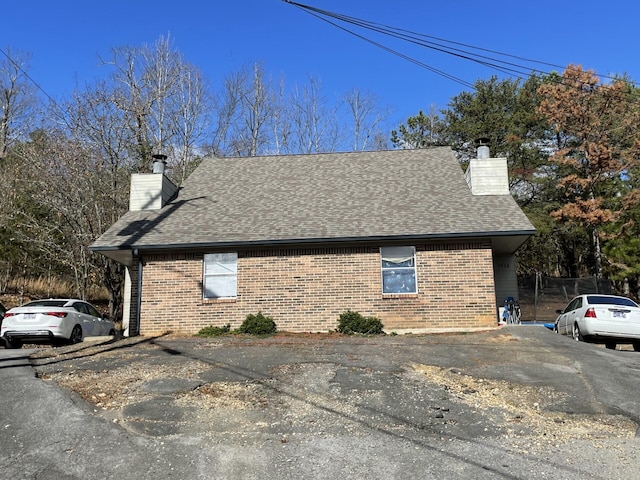 4813/4815 Charwood Trl NW, Cleveland, TN 37312 - view of side of home with a chimney, roof with shingles, and brick siding