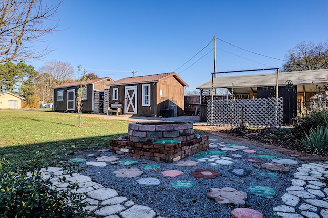 exterior space featuring a storage unit, an outdoor fire pit, and a lawn