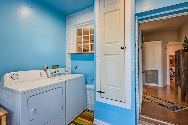 laundry area with hardwood / wood-style floors and separate washer and dryer