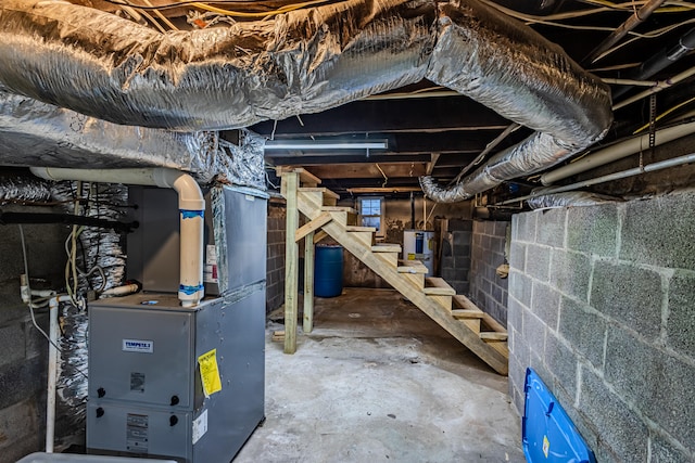 basement featuring heating unit and water heater