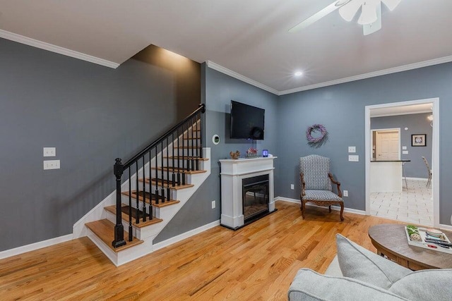 2036 Hickory Valley Rd, Chattanooga, TN 37421 - living room with ornamental molding, stairs, wood finished floors, a ceiling fan, and baseboards