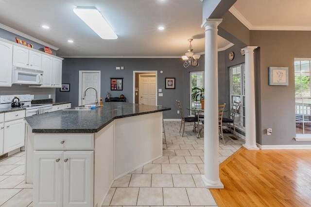 2036 Hickory Valley Rd, Chattanooga, TN 37421 - kitchen featuring white appliances, ornate columns, a sink, crown molding, and dark countertops