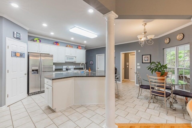 2036 Hickory Valley Rd, Chattanooga, TN 37421 - kitchen featuring stainless steel fridge, crown molding, white microwave, decorative columns, and white cabinets
