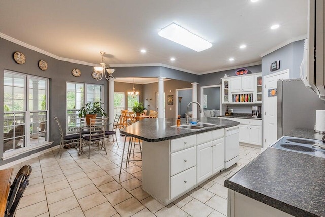 2036 Hickory Valley Rd, Chattanooga, TN 37421 - kitchen featuring a sink, ornate columns, dishwasher, dark countertops, and a chandelier