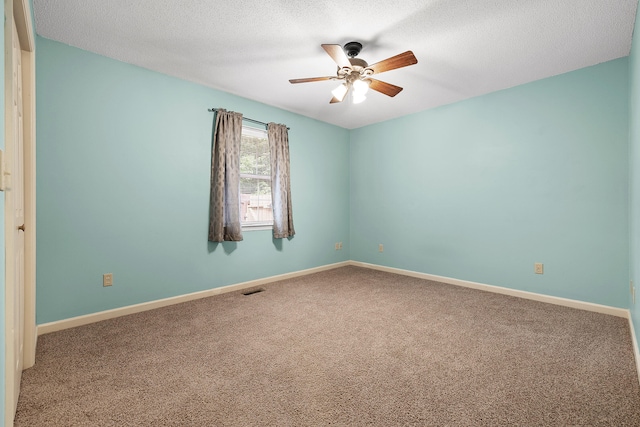 spare room with ceiling fan, carpet, and a textured ceiling