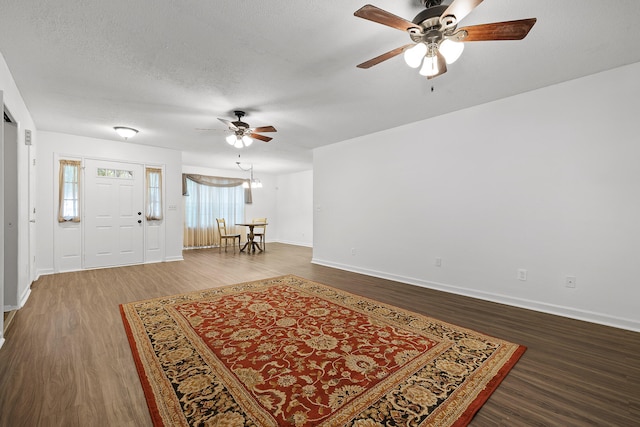 entrance foyer featuring ceiling fan, wood-type flooring, and a textured ceiling