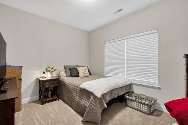 carpeted bedroom with baseboards and visible vents