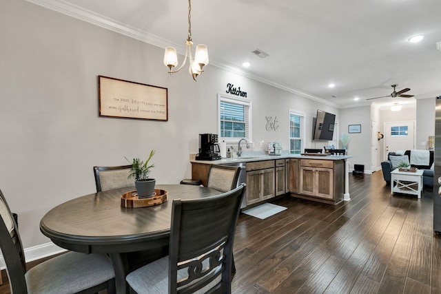 dining area with dark wood-type flooring, baseboards, visible vents, and crown molding