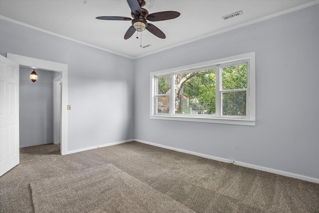 carpeted spare room featuring ceiling fan and crown molding