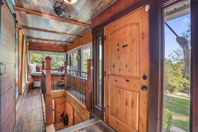 interior space with beam ceiling, wooden walls, wooden ceiling, and hardwood / wood-style flooring