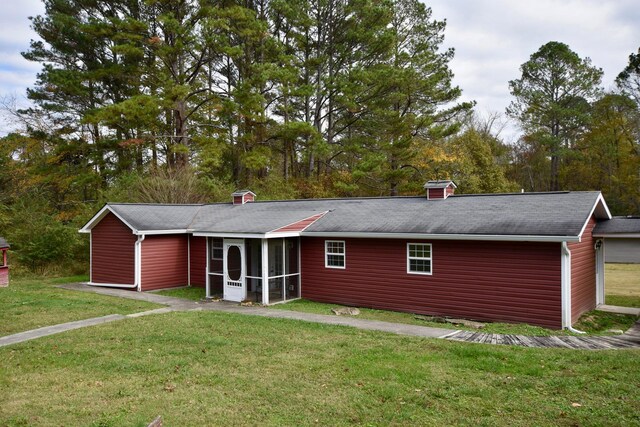 view of front of property with a front lawn and a sunroom