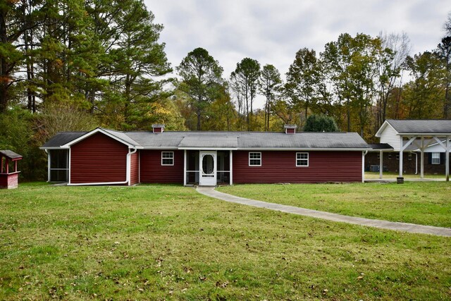 ranch-style home with a front lawn