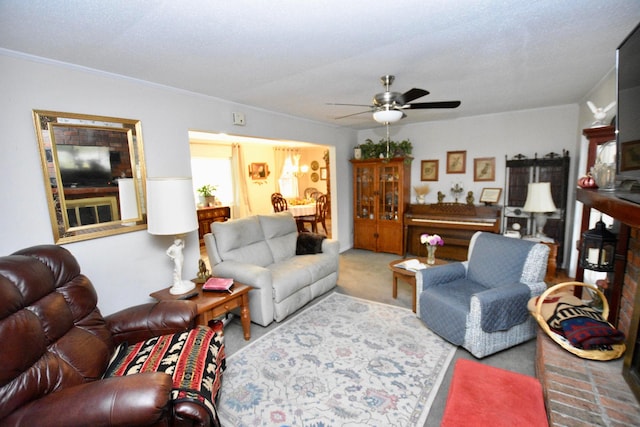 carpeted living room featuring ceiling fan and a textured ceiling