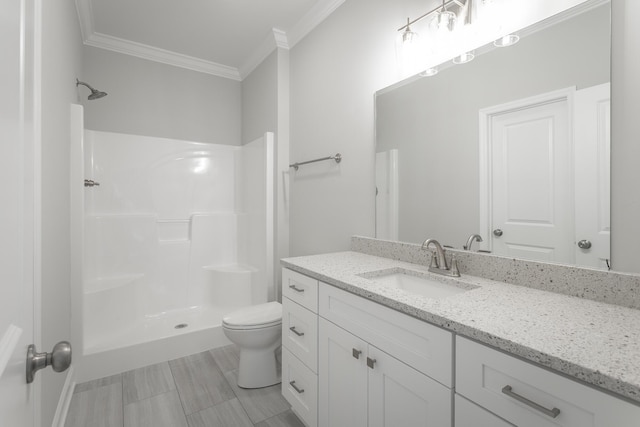 bathroom featuring vanity, toilet, walk in shower, and crown molding