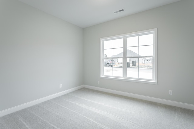 unfurnished room featuring carpet flooring and a healthy amount of sunlight