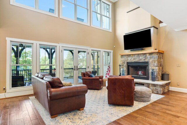302 Key Cove Rd, Spring City, TN 37381 - living room with a fireplace, french doors, baseboards, a towering ceiling, and hardwood / wood-style flooring