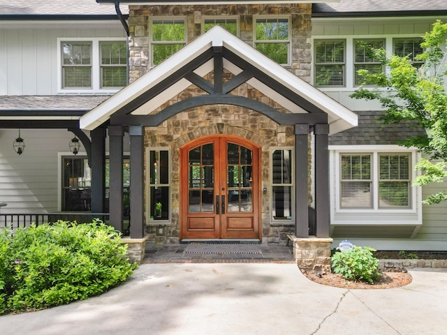 302 Key Cove Rd, Spring City, TN 37381 - view of exterior entry featuring french doors, board and batten siding, roof with shingles, and stone siding