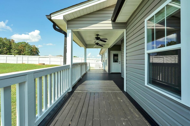 deck with a yard and ceiling fan