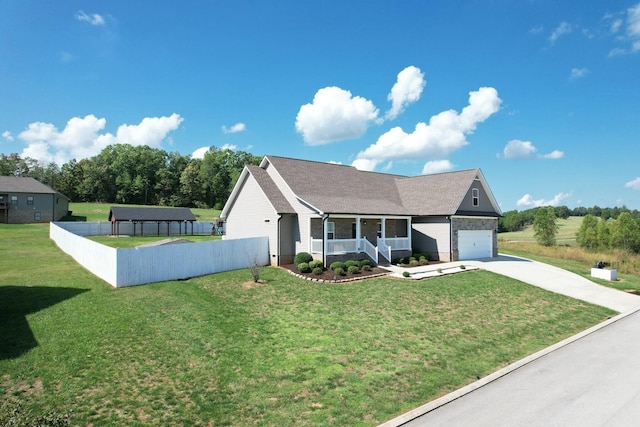 view of front facade with a garage, a front lawn, and covered porch