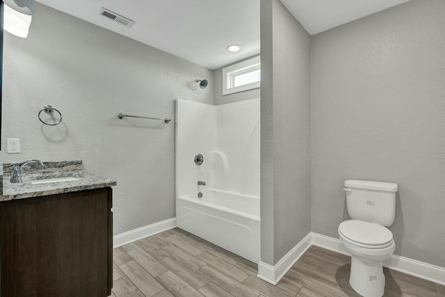 full bathroom featuring vanity, wood-type flooring,  shower combination, and toilet