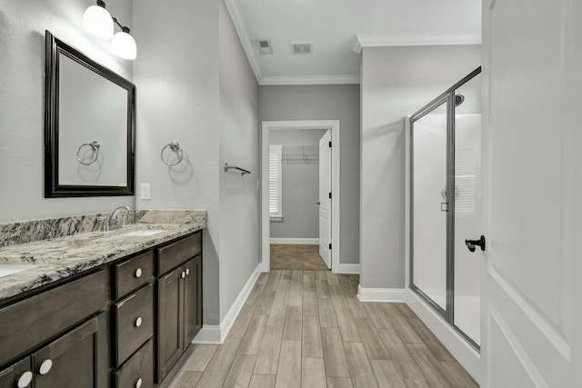 bathroom featuring crown molding, vanity, walk in shower, and hardwood / wood-style flooring