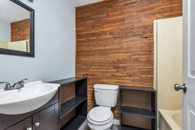 604 N Moore Rd, Chattanooga, TN 37411 - full bathroom featuring wooden walls, vanity, and a tub to relax in