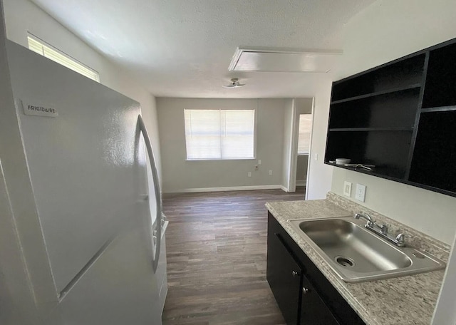 604 N Moore Rd, Chattanooga, TN 37411 - kitchen with freestanding refrigerator, dark cabinetry, dark wood-style flooring, light countertops, and a textured ceiling
