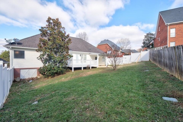 view of yard with a fenced backyard and a deck