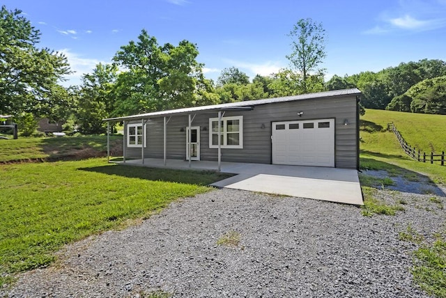 1295 Ideal Valley Rd, Spring City, TN 37381 - view of front of house with gravel driveway, a front lawn, a garage, metal roof, and covered porch