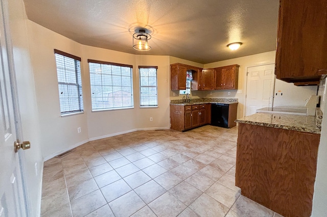 kitchen featuring visible vents, plenty of natural light, stone counters, and black dishwasher