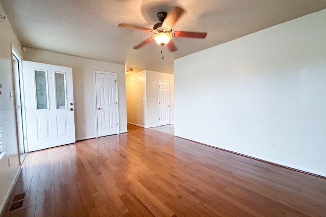 spare room featuring baseboards, a ceiling fan, and wood finished floors