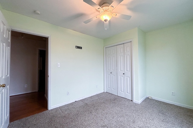 unfurnished bedroom with a closet, baseboards, carpet, and ceiling fan