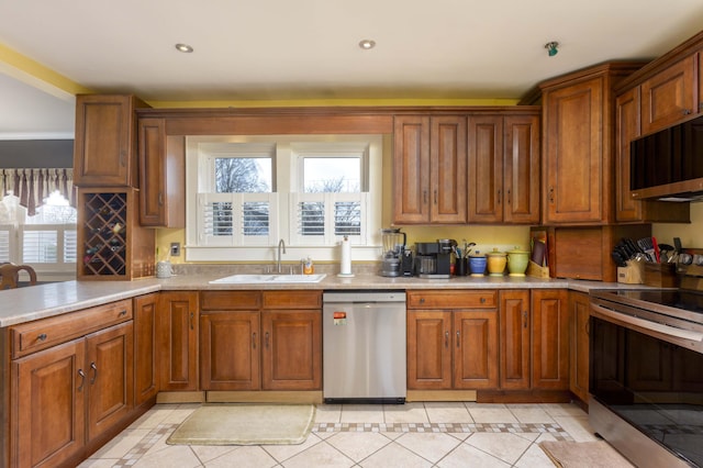 kitchen featuring appliances with stainless steel finishes, light tile patterned floors, and sink