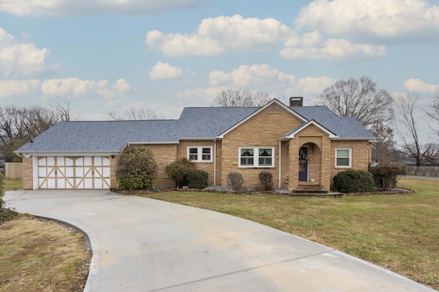 view of front of house with a garage and a front yard