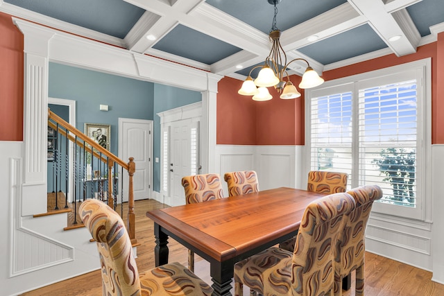 dining area with beam ceiling, crown molding, light hardwood / wood-style flooring, and coffered ceiling