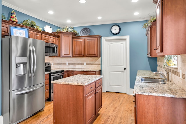 kitchen featuring crown molding, sink, stainless steel appliances, and light hardwood / wood-style flooring