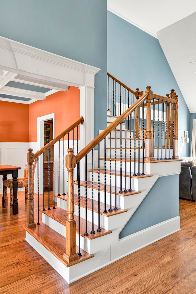 stairway featuring hardwood / wood-style floors and beamed ceiling