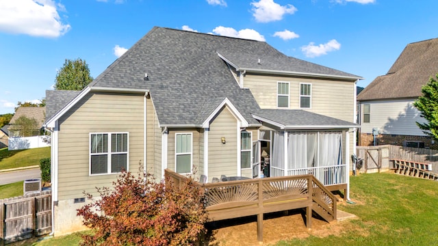 rear view of property with a yard and a deck