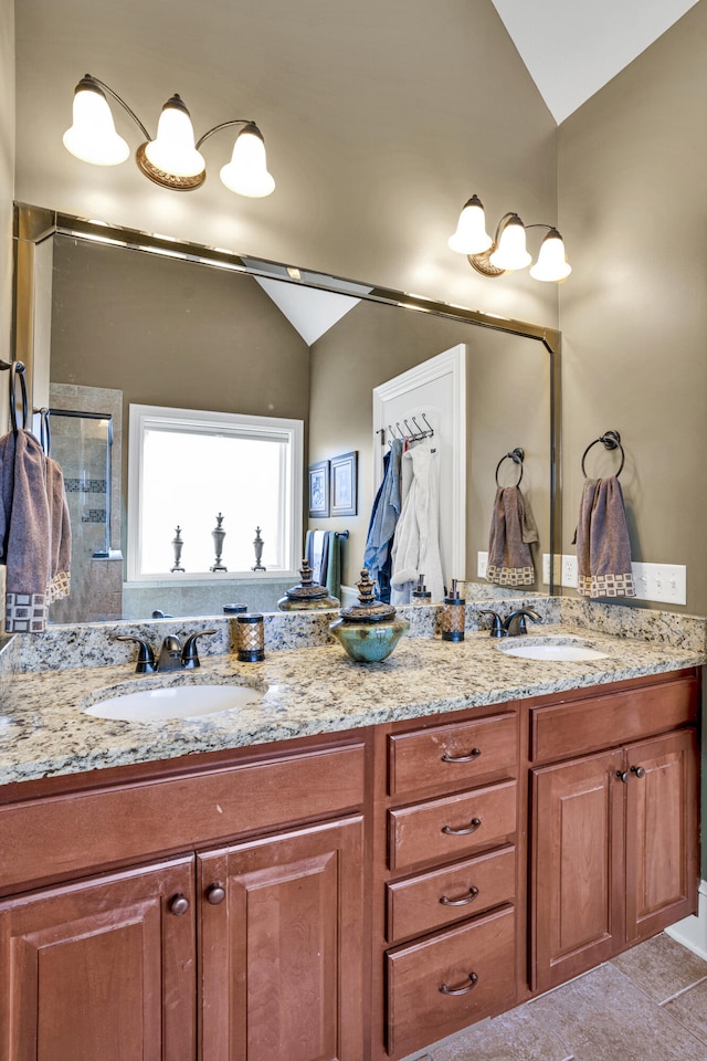 bathroom featuring tile patterned flooring, vanity, lofted ceiling, and walk in shower