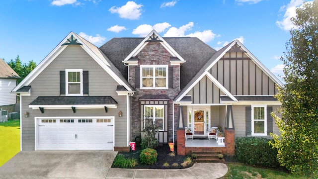 craftsman inspired home featuring a porch, a garage, and central AC