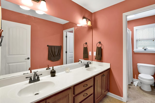 bathroom featuring toilet, vanity, and tile patterned floors