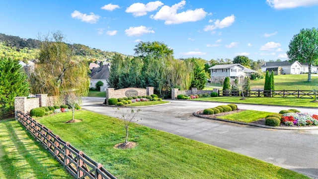 view of home's community featuring a lawn