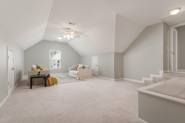 interior space featuring ceiling fan, lofted ceiling, and light carpet