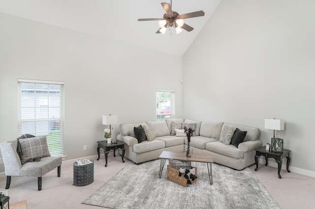 carpeted living room with plenty of natural light, ceiling fan, and high vaulted ceiling