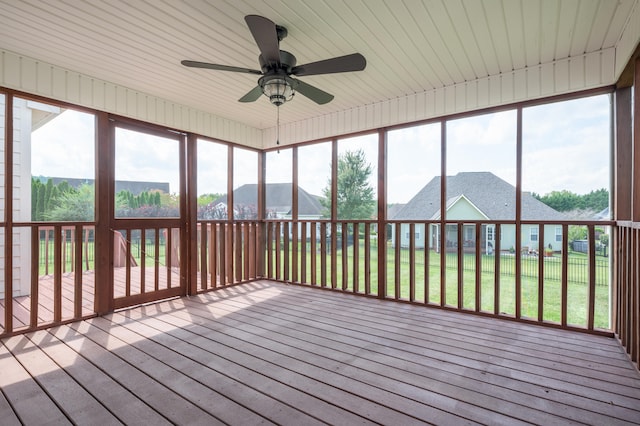 unfurnished sunroom featuring ceiling fan