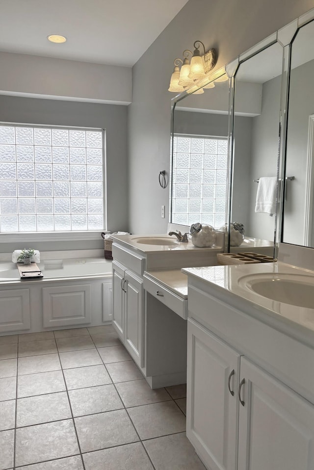 bathroom featuring tile patterned floors, vanity, and a tub to relax in