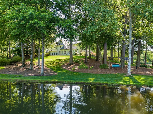 surrounding community featuring a yard and a water view