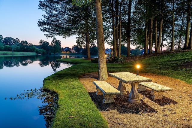 view of community with a water view and a yard