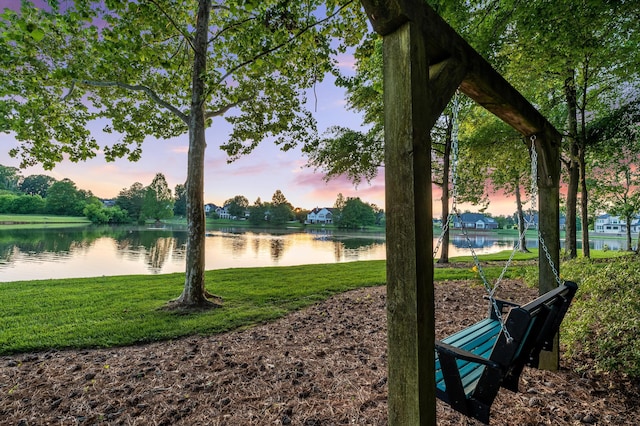 view of property's community with a yard and a water view