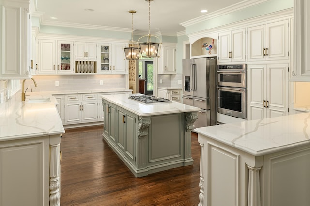 kitchen featuring open shelves, light stone countertops, dark wood-style floors, a sink, and appliances with stainless steel finishes